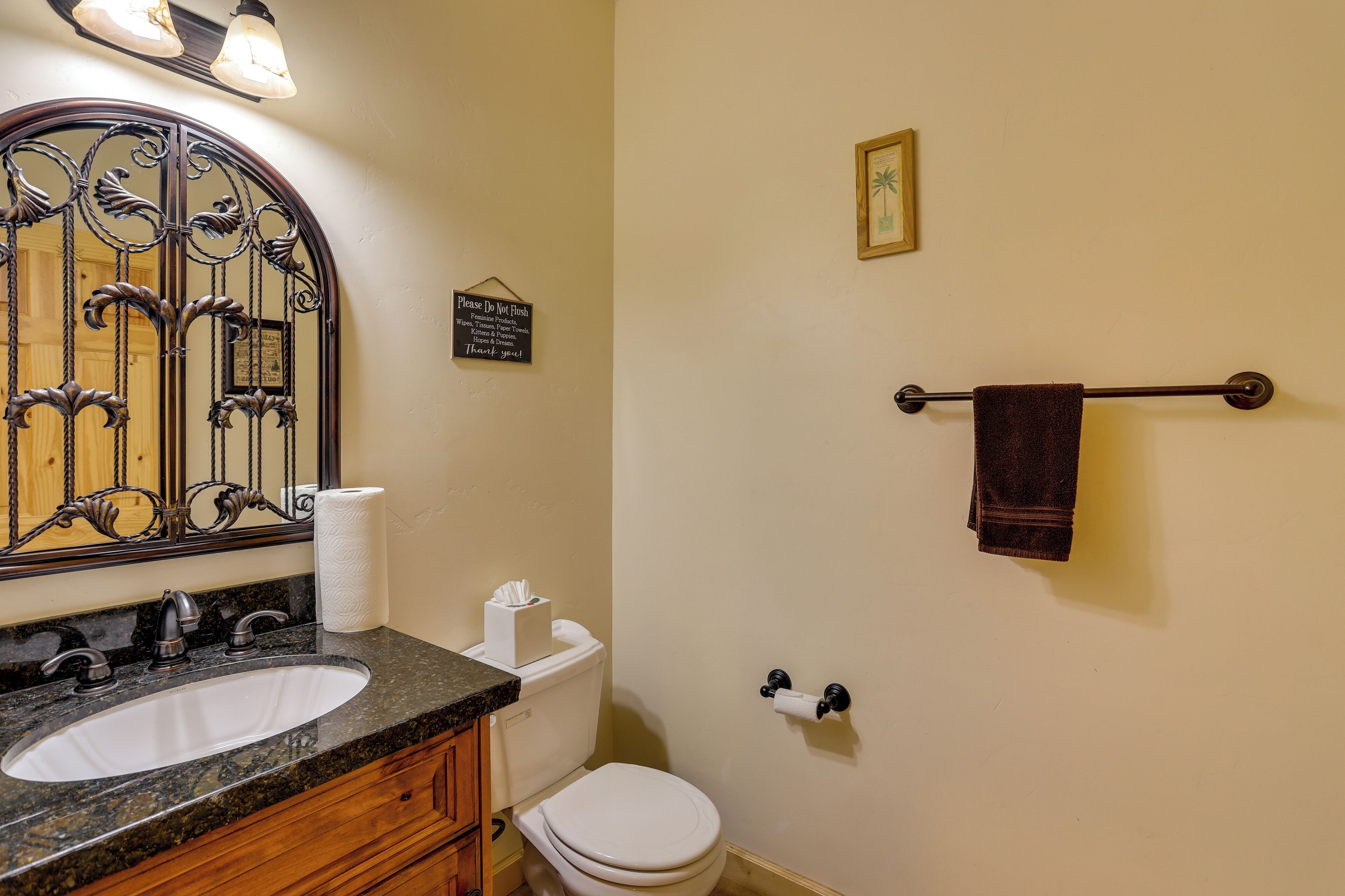 A bathroom with a sink, toilet, and towel rack.