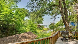 A wooden deck with a view of a river and trees. - Lake View & Decks: Pet-friendly Mabank Home (Mabank)