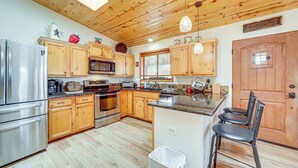 A kitchen with wooden cabinets, stainless steel appliances, and a wooden ceiling. - Strawberry Hideaway in the Pines w/ Hot Tub! (Pine)