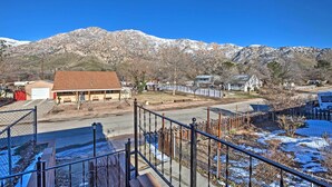 A residential area with a house, a garage, and a mountain backdrop.