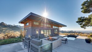 A modern house with a fire pit and outdoor seating. - Luxe, Modern Studio w/ Sweeping City Views! (Boise)