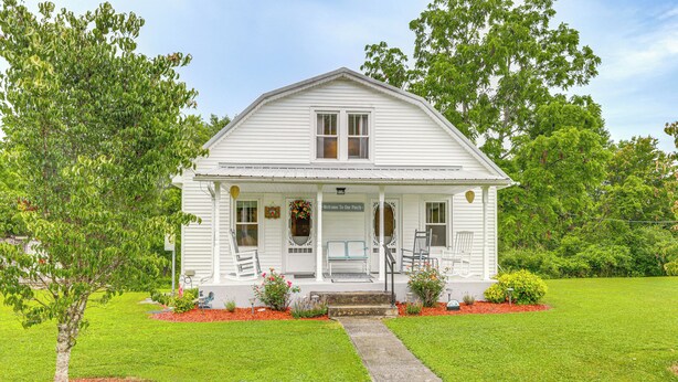 A white two-story house with a porch, a small front yard, and a pathway leading to the entrance. - 'grandma's Farm House' on 125 Acres w/ Fire Pit! (Beattyville)