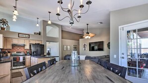 A spacious kitchen with modern appliances, a large dining table, and a cozy seating area. - Beautiful Backyard: Comfortable Phoenix Getaway! (Phoenix)