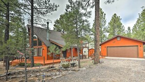 A two-story house with a garage, surrounded by trees. - 1 Mi to Lake: Secluded Cabin w/ Deck in Munds Park (Munds Park)