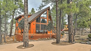 A modern cabin with a large deck, surrounded by tall pine trees. - 1 Mi to Lake: Secluded Cabin w/ Deck in Munds Park (Munds Park)