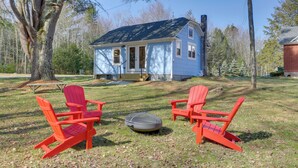 A house with a blue exterior and a chimney, surrounded by trees and a grassy yard. - Cozy Catskills Tiny Home ~ 3 Mi to Bethel Woods! (Swan Lake)