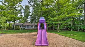 A playground with a purple slide and a frog-themed play structure. - Spacious Tobyhanna Family Home: Pool/beach Access! (Tobyhanna)
