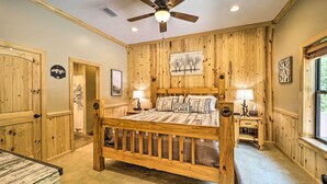 A bedroom with a wooden bed, a ceiling fan, and a window. - 10 Mi to Grandfather Mountain: 'wolfe Creek Cabin' (Newland)