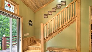 A wooden staircase with a handrail, a wooden bench, and a door leading outside. - 10 Mi to Grandfather Mountain: 'wolfe Creek Cabin' (Newland)