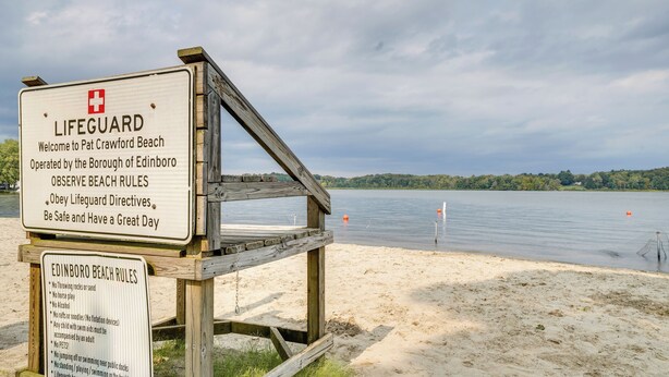 A lifeguard sign at Pat Crawford Beach with beach rules and a wooden structure. - Walk to Beach & Lake: Idyllic Escape in Edinboro! (Edinboro)