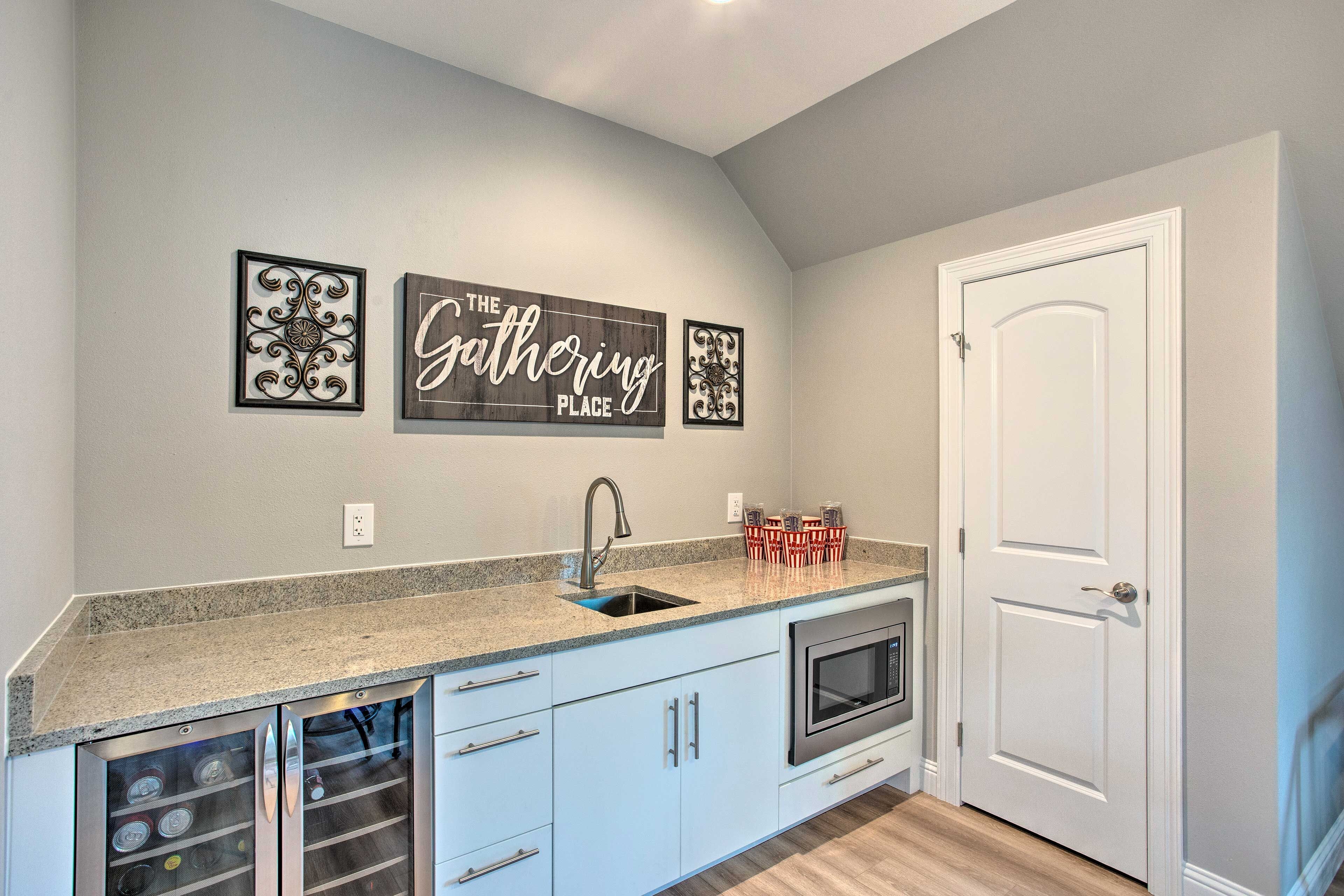 A kitchen with a granite countertop, a built-in oven, and a white door.
