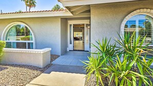 A house with a covered patio, arched windows, and a view of the interior. - Pool, Hot Tub: Family-friendly Scottsdale Home! (Scottsdale)