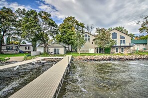 A residential area with houses, a dock, and a small stream. - Delightful Isle Retreat w/ Boat Dock & Slip! (Isle)