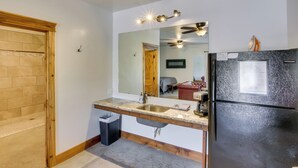 A kitchen with a granite countertop, stainless steel sink, and a black refrigerator. - Lava Hot Springs Studio w/ Views, Walk to River (Lava Hot Springs)