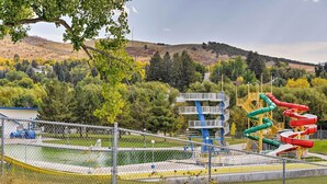 A fenced playground with multiple slides and a water feature. - Lava Hot Springs Studio w/ Views, Walk to River (Lava Hot Springs)