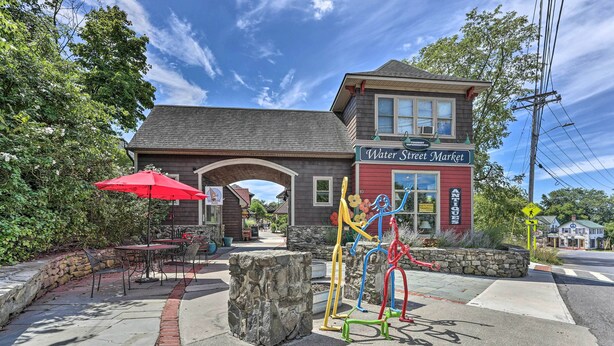 A building with a sign reading "Water Street Market" and a playground with colorful equipment. - Wallkill Riverfront Retreat: Canoe & Relax! (New Paltz)