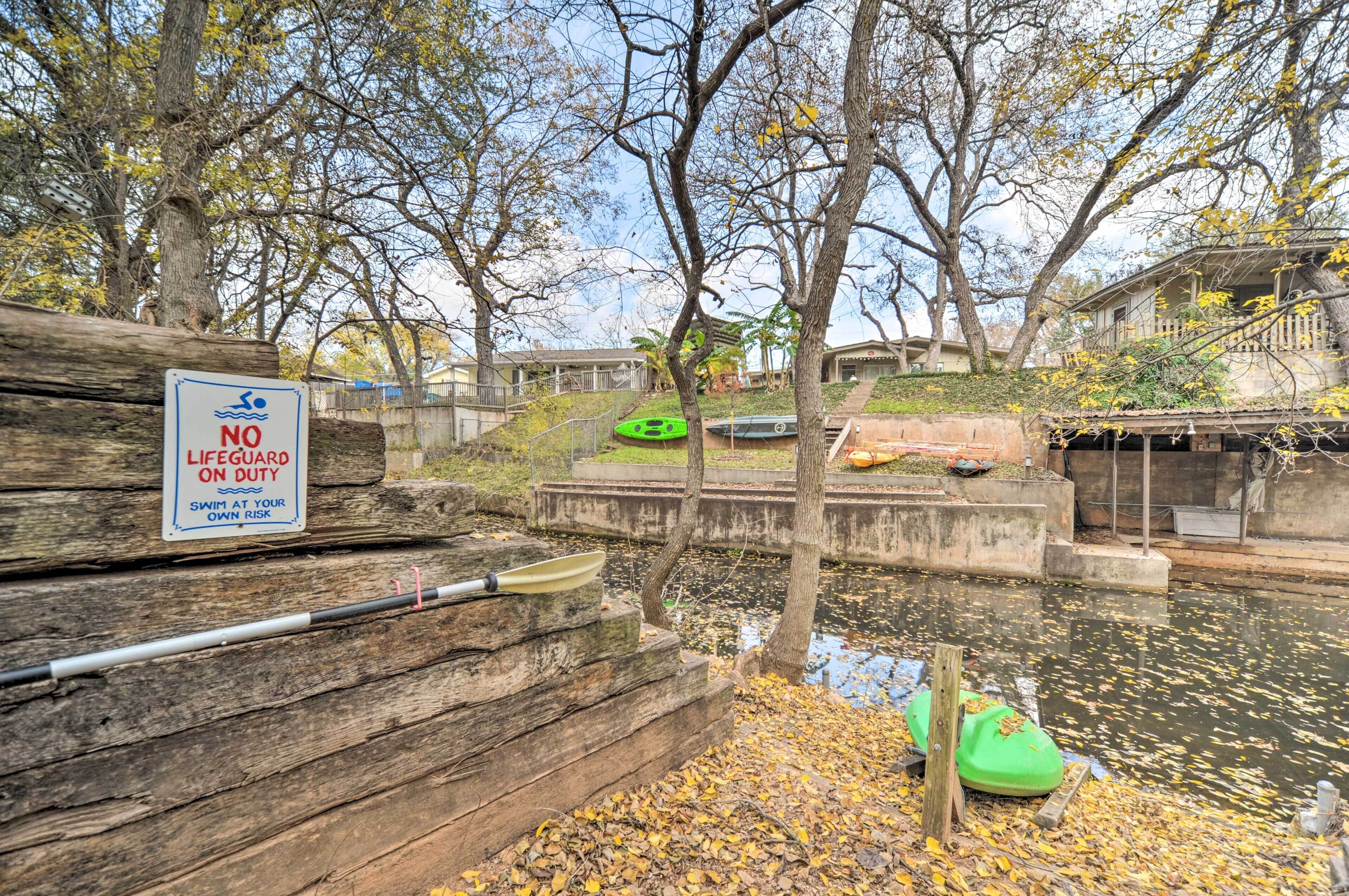 A wooden dock with a sign warning against swimming without a lifeguard.