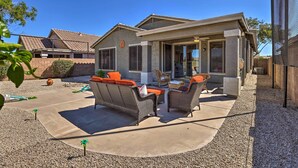 A house with a patio area featuring outdoor furniture and a covered section. - San Tan Valley Home w/ Pool Access & Golf View! (San Tan Valley)