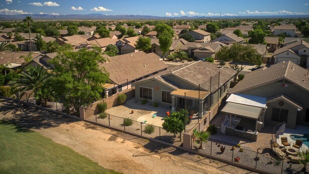 A residential area with houses, a fenced yard, and a clear view of the mountains in the distance. - San Tan Valley Home w/ Pool Access & Golf View! (San Tan Valley)