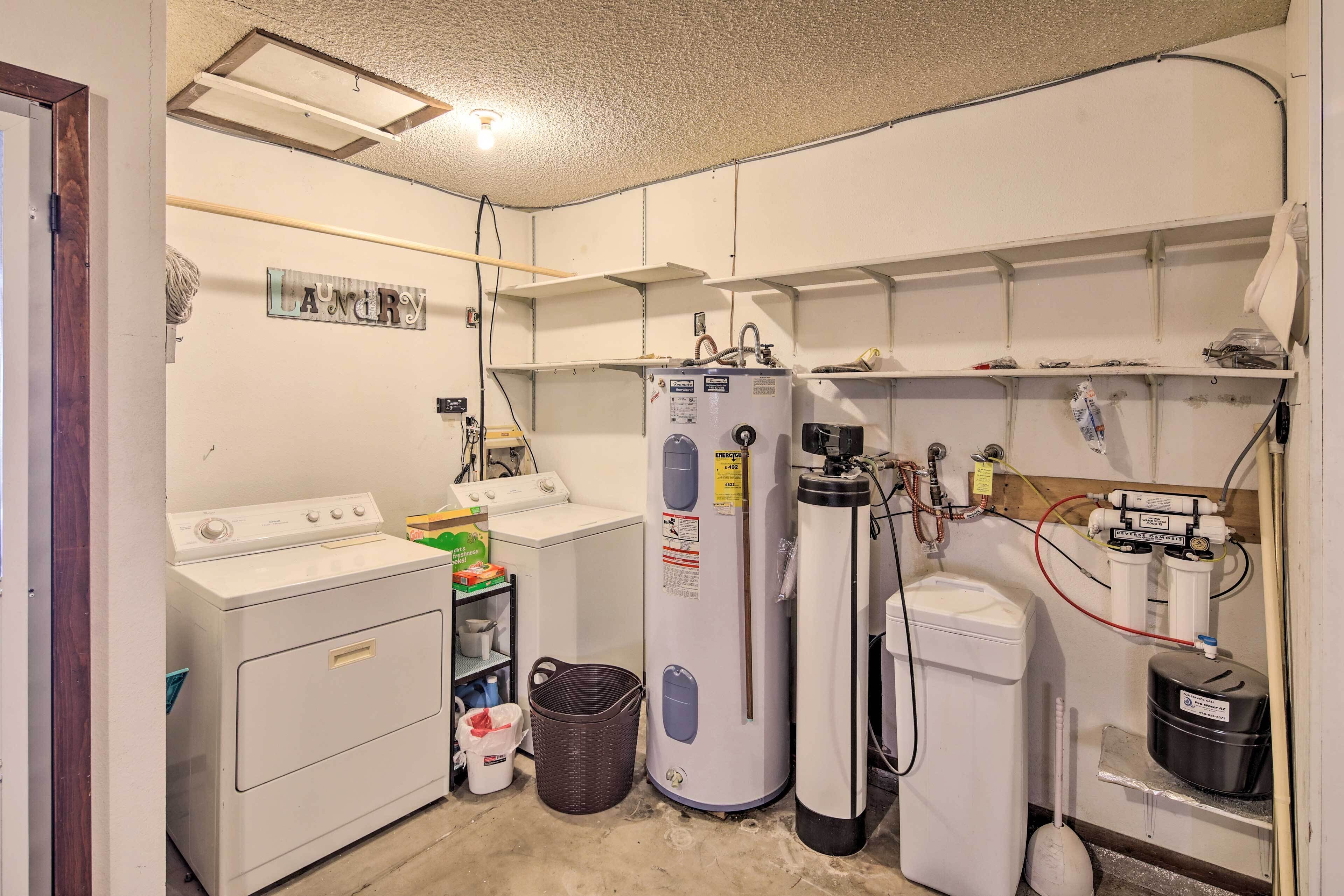 A laundry room with a washer, dryer, and water heater.