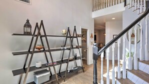 A staircase with white balusters and a dark wooden handrail.