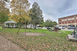 A park with a gazebo, swing set, and a historical carriage. - Pet-friendly Home - 1/2 Mi to Downtown Willoughby! (Willoughby)