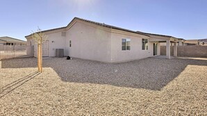 A single-story building with a flat roof and a gravel driveway. - Modern Kingman Vacation Rental, 5 Mi to Dtwn! (Kingman)