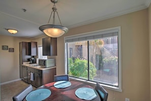 Enjoy meals in this cozy dining area with a view of the lush garden.