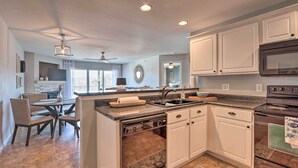 A modern kitchen with white cabinets, a built-in oven, and a dishwasher. - Relax Poolside! 'serenity at the Lake' in Ozarks (Camdenton)