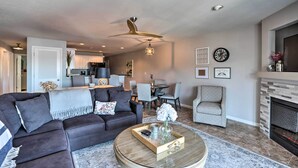 A modern living room with a sectional sofa, a round coffee table, and a fireplace. - Relax Poolside! 'serenity at the Lake' in Ozarks (Camdenton)