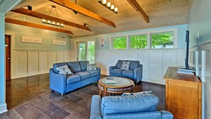 A spacious living room with two sofas, a coffee table, and a wooden cabinet. - Common Fence Point Cottage w/ Ocean Views! (Portsmouth)