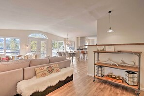 A spacious living room with a large sofa, a wooden coffee table, and a decorative shelf with antlers and lanterns. - Mountain Cabin w/ Views + Firepit: 25 Mi to Skiing (Fairplay)