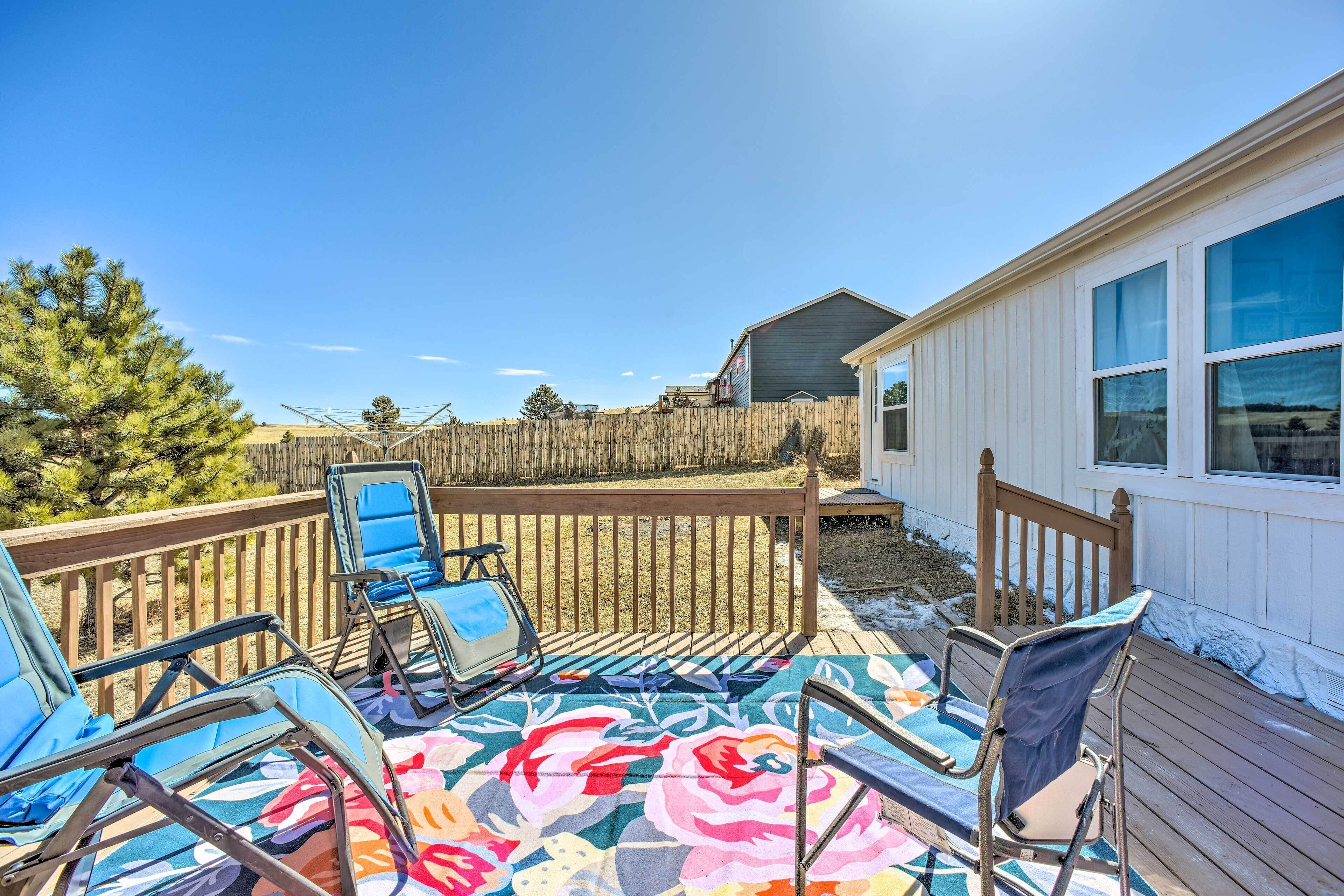 A covered patio with outdoor furniture and a wooden deck.