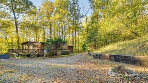 A cabin with a gravel driveway, surrounded by trees and a stone retaining wall. - Stanardsville Cabin Rental ~ 24 Mi to Shenandoah! (Stanardsville)