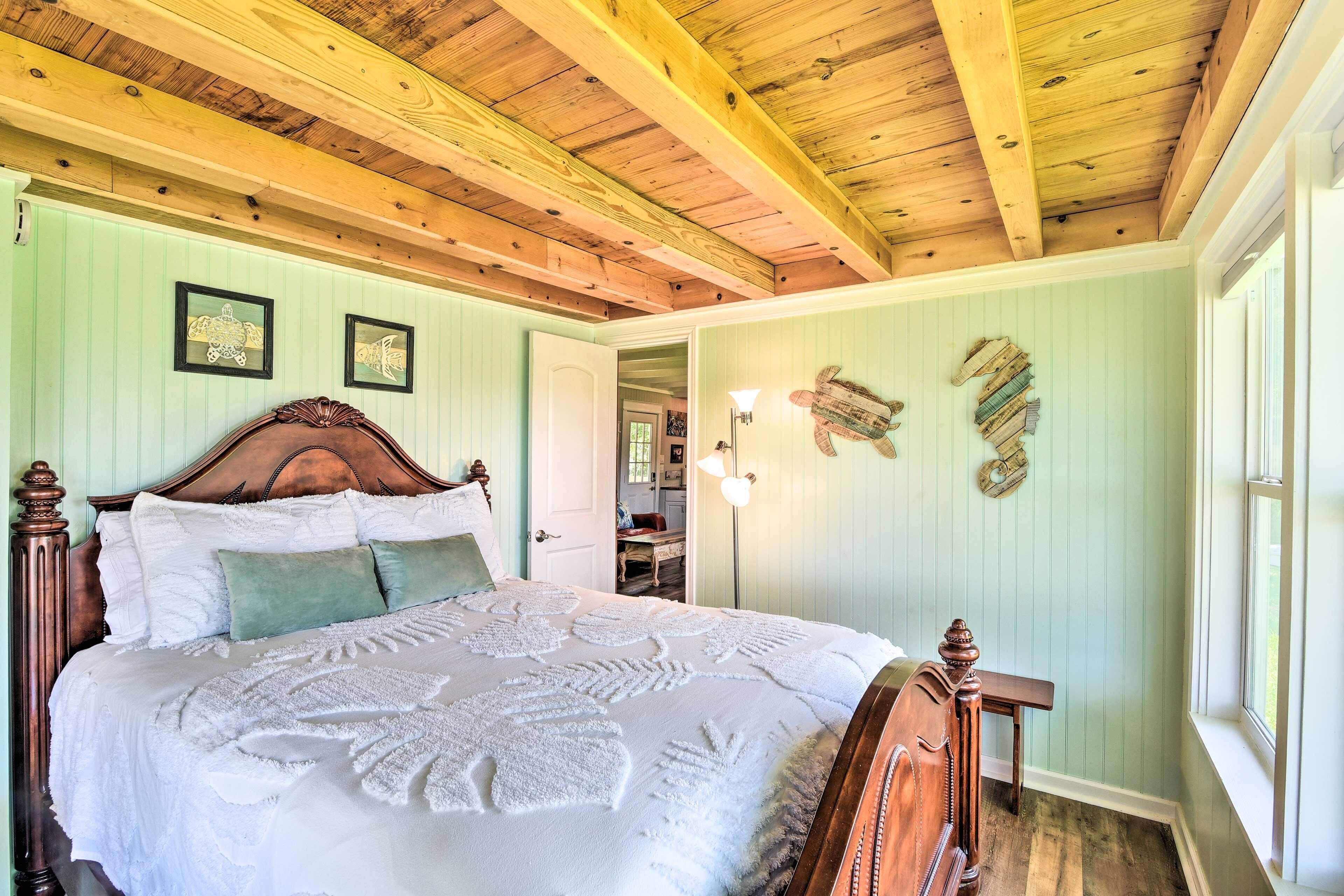 A bedroom with a wooden bed, a nightstand, and a window.