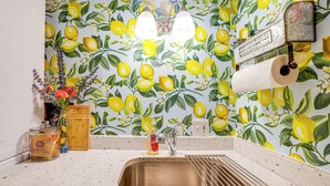 A kitchen with a stainless steel sink, a wooden cutting board, a bottle of dish soap, and a vase with flowers. - Charming Getaway < 1 Mi to Downtown Lambertville! (Lambertville)
