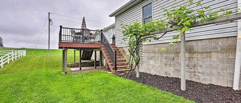 A two-story house with a balcony and a small staircase leading to the upper floor.