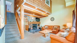 A multi-level living space with a staircase, a fireplace, a sofa, and a coffee table. - Lake Harmony Condo < 1 Mi to Big Boulder Mountain! (Lake Harmony)