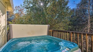 A hot tub on a wooden deck with a view of trees and a clear sky. - Wine Country Escape w/ Hot Tub in River Pines! (River Pines)