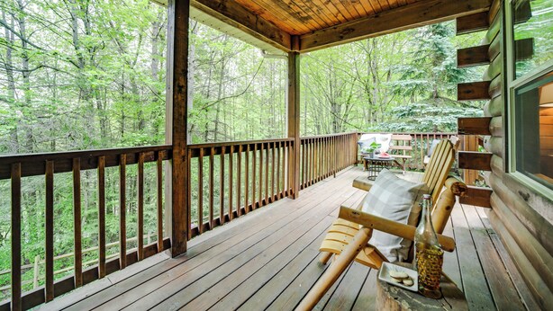 Una terraza de madera con vistas a un bosque.