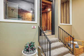 A staircase with a wooden handrail, a small wooden bench, and a potted plant at the bottom. - Spacious Brian Head Mtn Getaway w/ Hot Tub! (Brian Head)