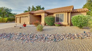 A single-story house with a tiled roof, a front garage, and a gravel driveway. - Fenced Hot Tub & Bbq: Modern Scottsdale Retreat (Scottsdale)