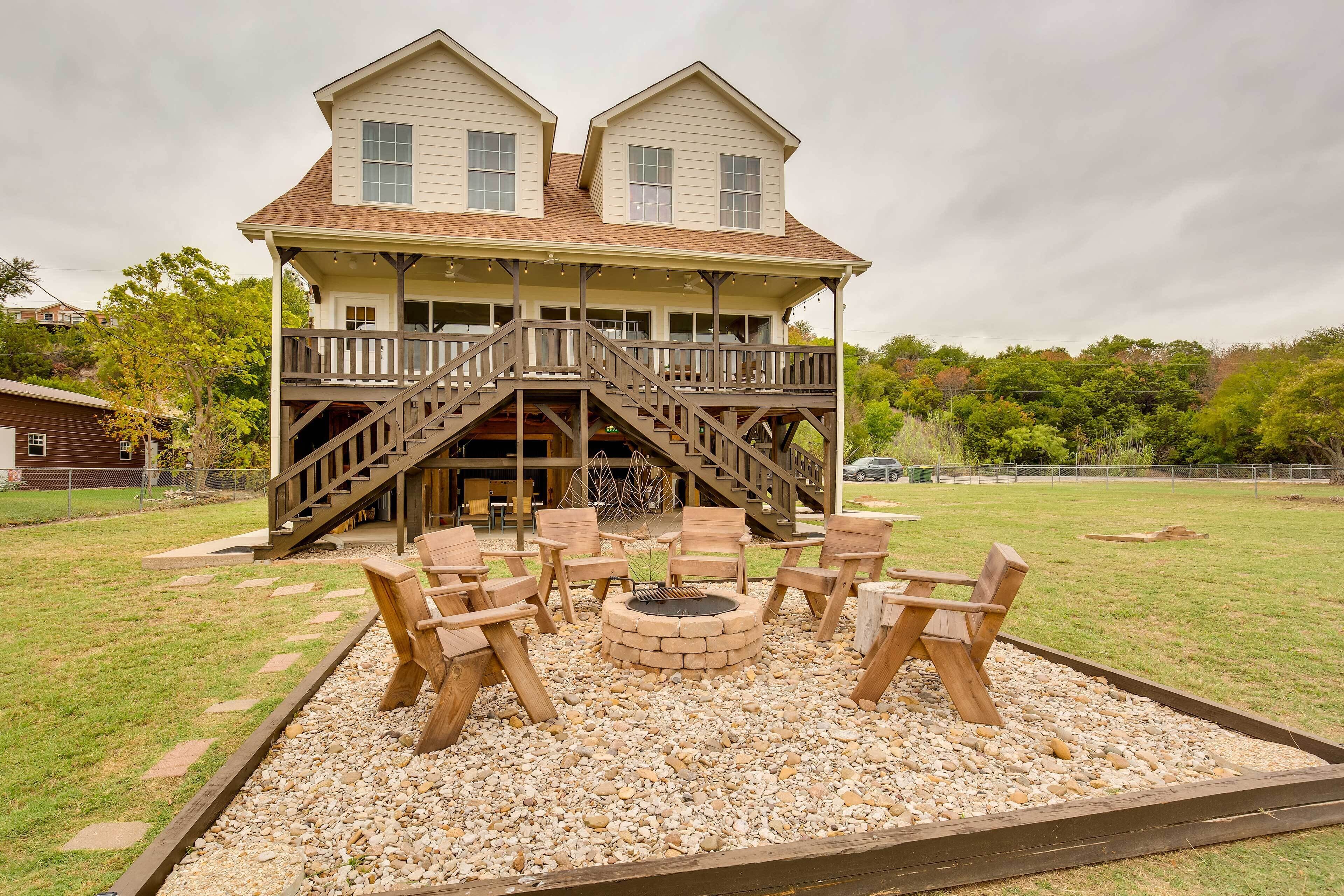 A two-story house with a wooden deck and outdoor seating area.