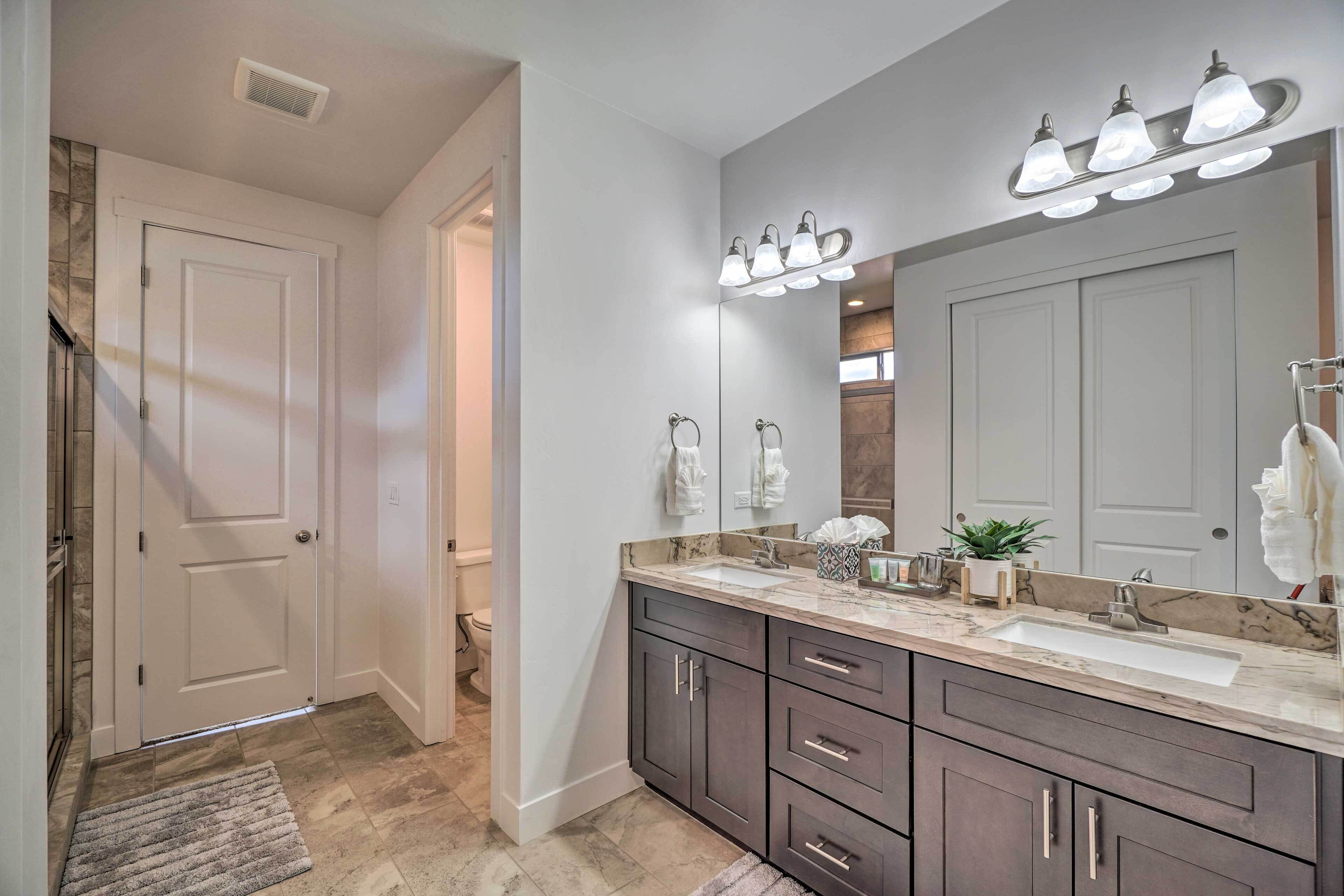 A modern bathroom with a large vanity, a double sink, and a mirror above the sink.