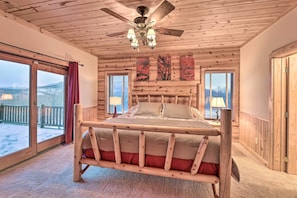 Relax in this serene bedroom with a comfortable bed, large windows, and soft lighting.