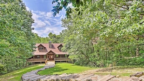 A lodge with a wooden exterior, a covered porch, and a stone chimney. - Spacious & Secluded Cabin: 25 Mi to Bentonville! (Sulphur Springs)