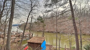 A lakeside cabin with a dock and a small shed. - Relaxing Retreat w/ Private Dock on Claytor Lake! (Dublin)