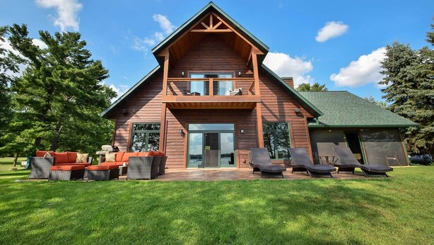A wooden cabin with a balcony, outdoor seating, and a view of the surrounding landscape. - Cabin w/ Gradual Slope to Sandy Bottom Swimming! (Siren)