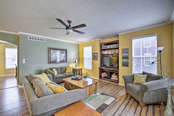 A living room with a sofa, coffee table, and bookshelf.