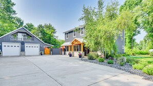 A modern two-story house with a garage, a covered porch, and a landscaped front yard. - Benton Harbor Apt w/ Balcony + Fire Pit (Benton Harbor)